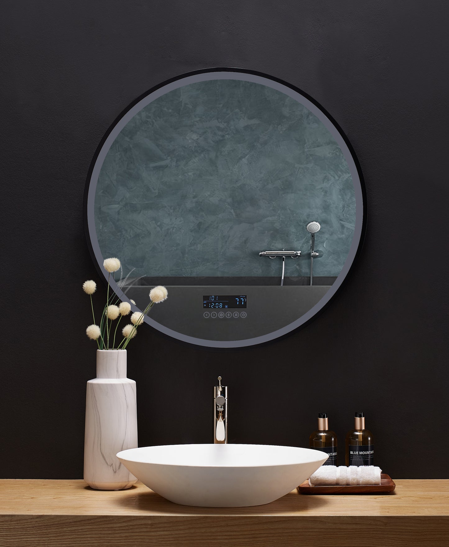 A round mirror is affixed above a bathroom vanity. The LED lighting around the edge of the mirror is off.