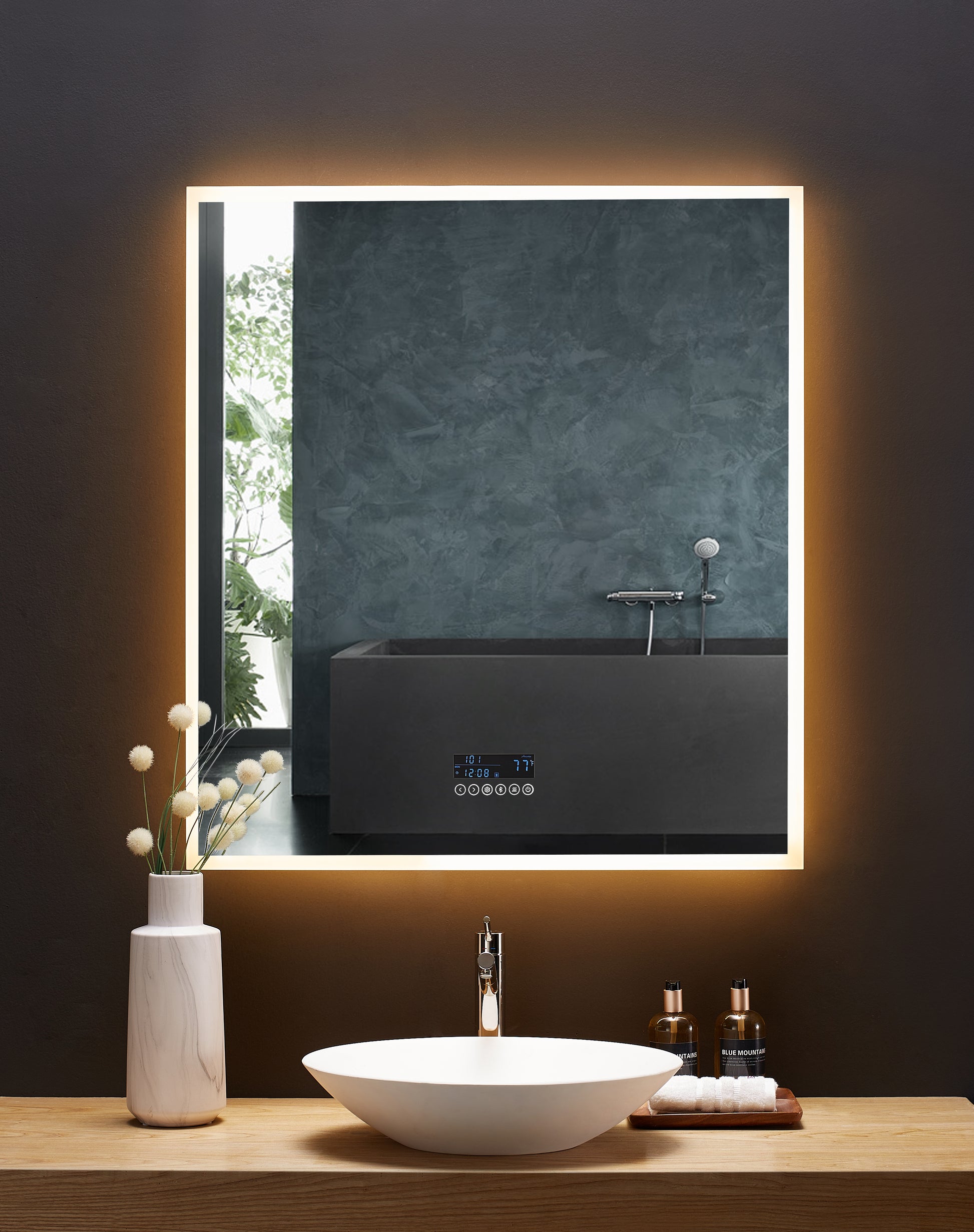 Image shows rectangular mirror with LED illumination on perimeter.  Mirror is mounted above bathroom vanity.